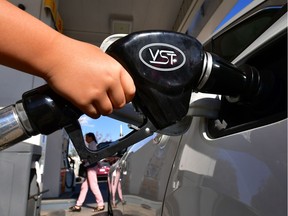 (FILES) In this file photo taken on April 9, 2019 a child pumps gas for his father at a gas station in Los Angeles, as southern California gas prices, already the highest in the nation, continue to rise. - President Donald Trump announced on September 15, 2019 that he has authorized the release of oil from US strategic reserves after drone attacks cut Saudi Arabia's crude production by half.