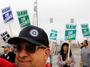 David Garcia, a United Auto Workers (UAW) member who is employed at the General Motors Co. Flint Assembly plant in Flint, Michigan, pickets outside of the plant as they strike on September 16, 2019. - The United Auto Workers union began a nationwide strike against General Motors on Monday, with some 46,000 members walking off the job after contract talks hit an impasse. The move to strike, which the Wall Street Journal described as the first major stoppage at GM in more than a decade, came after the manufacturer's four-year contract with workers expired without an agreement on a replacement.