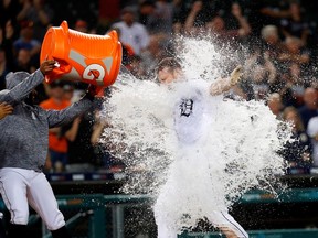 Detroit Tigers first baseman John Hicks is doused with water by third baseman Ronny Rodriguez after he hits a walk off grand slam in the 12th inning against the Baltimore Orioles at Comerica Park.