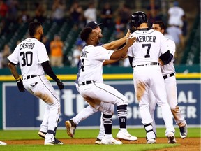 Detroit Tigers shortstop Jordy Mercer (7) receives congratulations from teammates after he hits a walk off hits an RBI single in the ninth inning against the New York Yankees at Comerica Park.