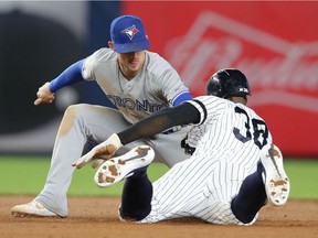 New York Yankees left fielder Cameron Maybin (38) is tagged out trying to steal second by Toronto Blue Jays second baseman Cavan Biggio (8) during the eighth inning at Yankee Stadium on Sept. 20, 2019.