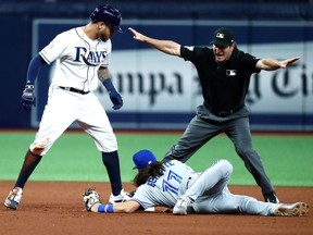 Tampa Bay Rays left fielder Tommy Pham (29) doubles as Toronto Blue Jays shortstop Bo Bichette (11) attempted to tag him out during the seventh inning at Tropicana Field in St. Petersburg.