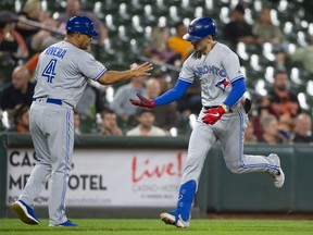 Toronto Blue Jays second baseman Cavan Biggio, right, celebrates with third base coach Luis Rivera after hitting a two run home run during the third inning against the Baltimore Orioles at Oriole Park at Camden Yards, Sept. 17, 2019. (Tommy Gilligan-USA TODAY Sports)