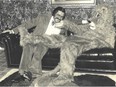 Bob Pedler chuckles next to his lion mascot during the opening of his Cabana Road office in 1974.