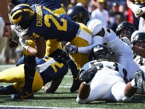 Michigan Wolverines running back Zach Charbonnet dives for a touchdown in overtime against the Army Black Knights at Michigan Stadium.