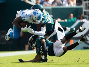 Detroit Lions running back Kerryon Johnson is tackled by Philadelphia Eagles inside linebacker Zach Brown and cornerback Sidney Jones during the fourth quarter at Lincoln Financial Field.