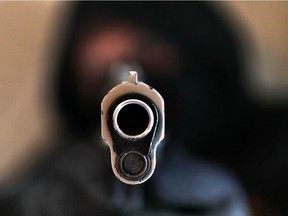 A man points a .45-calibre handgun in this 2013 Windsor file photo.