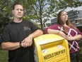 Brandon Bailey, a member of the Windsor Overdose Prevention Society, and Hannah Fudge, treasurer, are pictured next to a needle drop box in downtown Windsor, Friday, September 13, 2019.