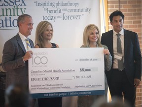 Kerri Hill, centre left, and Kim Willis of the local Canadian Mental Health Association branch receive an $8,000 cheque from Jonathan Allison, left, treasurer, and Andrew Tepperman, chair, of Inspiration 100 at the Windsor Club on Sept. 18, 2019.