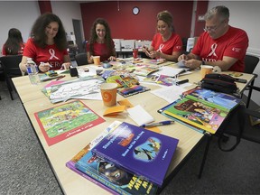 Employees from Caesars Windsor HEROs program volunteered to create literacy kits for local children on Thursday, September 12, 2019 at the United Way Windsor-Essex office. The kits contain books, literacy activities for parents, book marks and a personal letter to encourage reading. Erika Newman, left, Kathleen Jones, Tina Wakeford and Ed Fernandez are shown assembling the kits during the event.