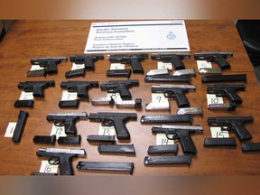 A cache of 15 handguns and 26 magazines seized by CBSA from a vehicle that tried to enter Canada via the Ambassador Bridge on June 20, 2019.