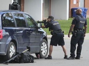 Windsor Police officers are shown in front of a home at the corner of Mercer and Elliot on Wednesday, September 4, 2019. The officers surrounded the home for several hours.