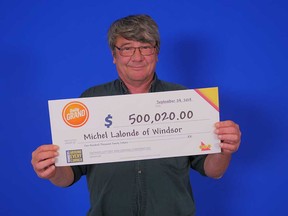 Michel Lalonde of Windsor holds his prize cheque from playing the OLG game Daily Grand. Photographed Sept. 24, 2019.