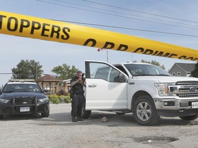 McGREGOR, ON. SEPTEMBER 10, 2019. --  An OPP forensic indentification officer takes photos of a truck that was the subject of an investigation on Tuesday, September 10, 2019, in McGregor, ON.