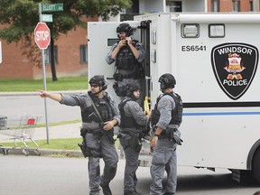 WINDSOR, ON. SEPTEMBER 4, 2019. -- Windsor Police officers with the emergency services unit are shown in front of a home at the corner of Mercer and Elliot on Wednesday, September 4, 2019. The officers surrounded the home for several hours.
