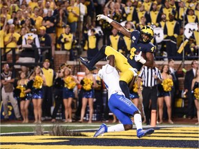 Michigan Wolverines wide receiver Nico Collins catches a touchdown pass as Middle Tennessee Blue Raiders safety Gregory Grate Jr. attempts to break up the play during the second quarter at Michigan Stadium.