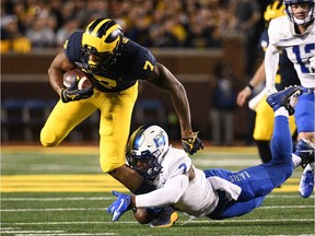 Michigan Wolverines wide receiver Tarik Black is tackled by Middle Tennessee Blue Raiders  safety Jovante Moffatt during the second quarter at Michigan Stadium.