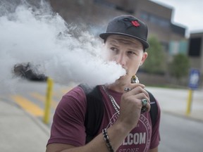 Trevor Torok, 29, takes a hit from his vape outside St. Clair College on Sept. 12, 2019.