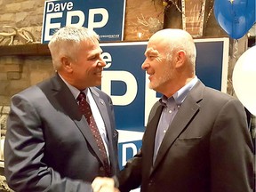 Conservative Dave Epp is greeted by retiring Conservative MP Dave Van Kesteren on Monday after he took the lead in the Chatham-Kent-Leamington riding to keep the seat Tory blue.