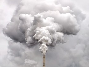 Smoke from a factory pipe against an overcast sky, showing air pollution. Getty Images.