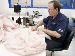 FILE - A Takata employee sews an airbag at Takata's current crash-testing facility August 19, 2010 in Auburn Hills, Michigan.