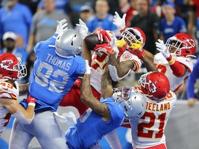 Jordan Lucas #24 of the Kansas City Chiefs battles for the Hail Mary in the fourth quarter against Logan Thomas #82  and Kenny Golladay #19 of the Detroit Lions at Ford Field on Sept. 29, 2019, in Detroit. The Chiefs defeated the Lions 34 -30.
