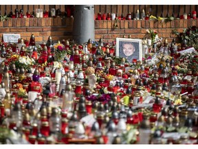 Mourners pay respects at the residence of Czech singer Karel Gott on Oct. 11, 2019, in Prague, Czech Republic. Karel Gott passed away last week at the age of 80 after suffering from acute leukemia. He sold tens of millions of albums in a career spanning almost six decades.