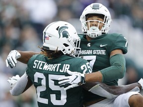Darrell Stewart Jr. of the Michigan State Spartans celebrates with Cody White after catching a pass for a five-yard touchdown in the second quarter against the Indiana Hoosiers at Spartan Stadium on September 28, 2019 in East Lansing, Michigan.