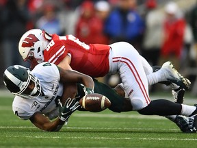 Mike Maskalunas of the Wisconsin Badgers defends a pass intended for C.J. Hayes of the Michigan State Spartans during the second half of a game at Camp Randall Stadium on October 12, 2019 in Madison, Wisconsin.