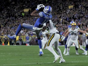 GREEN BAY, WISCONSIN - OCTOBER 14:  Marvin Jones Jr. #11 of the Detroit Lions makes a catch while being guarded by Kevin King #20 of the Green Bay Packers in the second quarter at Lambeau Field on October 14, 2019 in Green Bay, Wisconsin.