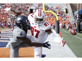 CHAMPAIGN, IL - OCTOBER 19: Nate Hobbs #8 of the Illinois Fighting Illini breaks up a pass in the end zone against Quintez Cephus #87 of the Wisconsin Badgers in the first half of the game at Memorial Stadium on October 19, 2019 in Champaign, Illinois.