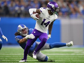 DETROIT, MICHIGAN - OCTOBER 20: Stefon Diggs #14 of the Minnesota Vikings tries to escape the tackle of Jahlani Tavai #51 of the Detroit Lions after a second half catch at Ford Field on October 20, 2019 in Detroit, Michigan. Minnesota won the game 42-30.