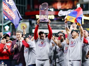Manager Dave Martinez #4 of the Washington Nationals hoists the Commissioners Trophy after defeating the Houston Astros 6-2 in Game Seven to win the 2019 World Series in Game Seven of the 2019 World Series at Minute Maid Park on Oct. 30, 2019, in Houston, Texas.