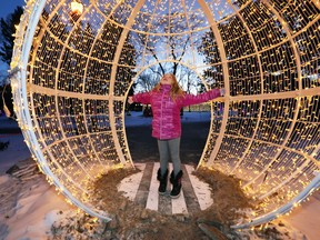 Adriana Ferguson leaps toward the sky while inside an oversized Christmas ornament at Bright Lights Windsor in this file photo from Jan. 5, 2018.
