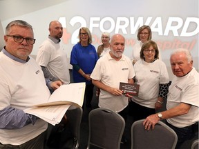 42 Forward - Our New Hospital organizers Joe McParland, left, Jeff Casey, Rona Warsh, Bev Valliquette, Brian Stocks, Brenda Brunelle, Janis Windsor and Gunther Wolf, right, gather for a briefing prior to a public rally at at Signature Tribute Events Centre on Dougall Avenue Thursday.