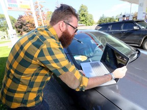 Lucas Jones uses his laptop and software to monitor raw radio frequency data on Oct. 8, 2019, as he attempts to find the source of strange electronic interference at an Amherstburg plaza.