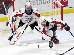 Windsor Spitfires defenceman Connor Corcoran (8) clears a rebound in front of goaltender Kari Piiroinen during Saturday's game against the Sarnia Sting at the WFCU Centre.