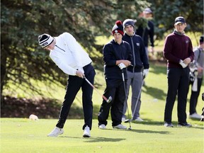 Tyler Hurtubise, left, of Essex, uses an iron on the 4th hole of Gold Nine at Kingsville Golf and Country Club. Hurtubise was on top, or near the top of the OFSSA leader board.  Hurtubise tee shot on 4th hole landed in the middle of the fairway, he made par on the hole.