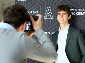 Derin Yilmaz, a Grade 12 student at Assumption high school, poses for a professional portrait taken by his classmate Evan Piatkowski, left, during 6th Annual High School Entrepreneurship Summit held at The Accelerator Wednesday.