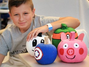 Paediatrics patient Antonio Mancini, 13, checks out colourful pumpkins which were painted by Sandwich Secondary School students and dropped off at Met Campus of Windsor Regional Hospital Wednesday morning.  Young patients had a chance to observe, then choose their favorite pumpkin, a Happy Halloween gift from Sandwich students.