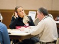 Megan Barrette, centre, a recent University of Windsor nursing graduate is interviewed by Henry Ford Health System's nursing recruiter Ron Scott, right, at Giovanni Caboto Club of Windsor Wednesday.