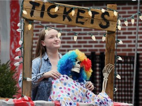 Simone Ryall, 13, helps out in the ticket booth of her mother's Halloween display called Welcome to the Circus at 1550 Ypres Blvd. Wednesday.