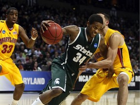 Korie Lucious of the Michigan State Spartans drives against Greivis Vasquez of the Maryland Terrapins during the second round of the 2010 NCAA men's basketball tournament at Spokane Arena on March 21, 2010 in Spokane, Washington.