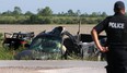 An Amherstburg police officer is seen at the scene of a serious collision at County Rd. 10 and Conc. 8 on Saturday, May 27, 2017. The driver of the pickup and the driver of the car were rushed to hospital with serious injuries.
