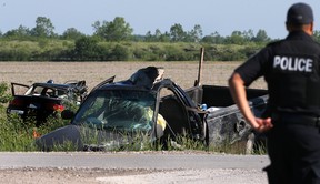 An Amherstburg police officer is seen at the scene of a serious collision at County Rd. 10 and Conc. 8 on Saturday, May 27, 2017. The driver of the pickup and the driver of the car were rushed to hospital with serious injuries.