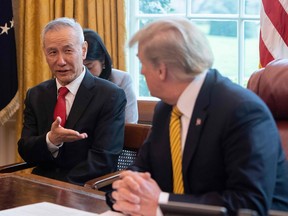 In this file photo taken April 4, 2019, China's Vice Premier Liu He speaks with U.S. President Donald Trump during a trade meeting in the Oval Office at the White House in Washington, DC. The White House announced on Oct. 7, 2019, that Beijing's top trade envoy Liu He will meet with U.S. Trade Representative Robert Lighthizer and Treasury Secretary Steven Mnuchin beginning on Thursday.