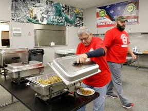 Louis Rocha, president of the United Auto Workers (UAW) Local 5960 serves himself lunch at their union hall on October 11, 2019 in Lake Orion, Michigan. - This union local represents workers at GM's Orion Assembly that is located in Orion Township, Michigan. As the General Motors strike grinds on, more auto suppliers and contractors are sending workers home, adding to the economic drag on Michigan and other US midwestern car manufacturing hubs."