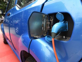 This photo taken on July 21, 2017 shows Mahindra's electric car "e2o Plus" plugged in for charging at a showroom in New Delhi.