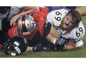 WINDSOR, ON. OCTOBER 27, 2019. --    Kyle Jennings, right, of the Windsor AKO Fratmen loses his helmet after colliding with Tevin Johnston of the London Beefeaters on Sunday, October 27, 2019, at the University of Windsor Alumni Stadium.