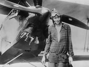 Amelia Earhart stands June 14, 1928 in front of her bi-plane called "Friendship" in Newfoundland.